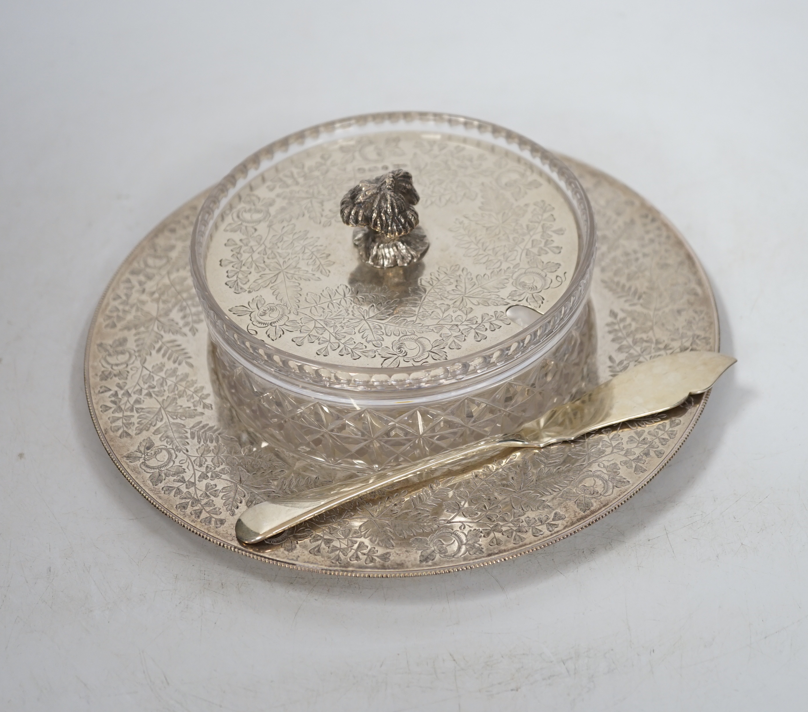 An Edwardian silver and glass butter dish, with engraved fern and rose decoration, Sheffield 1909, 428 grams of weighable silver, with an associated butter knife, 26 grams